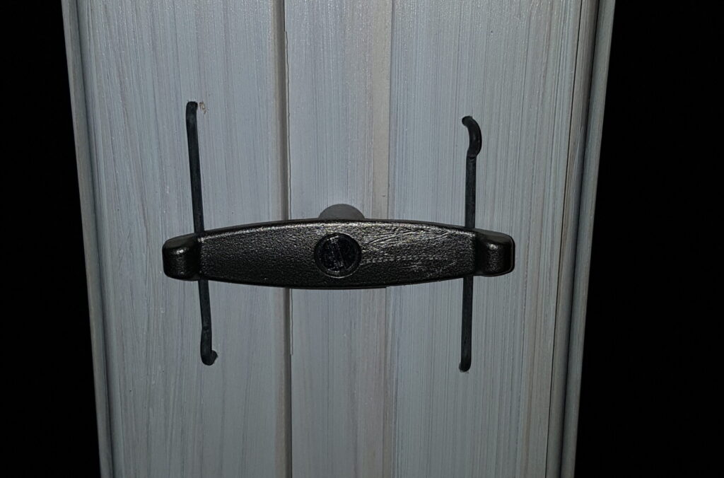 Detalj på öppningsbart innanfönster där bågen låses med vervel.